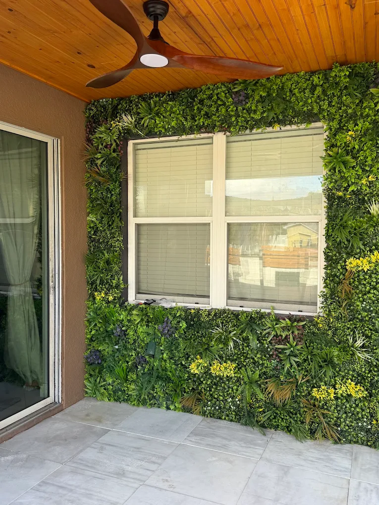 Covered patio with a wood ceiling and a green living wall framing a window